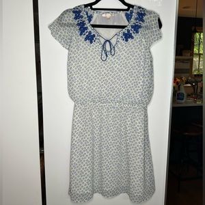 Skies are Blue Woman’s dress, white with blue embroidering and green accents